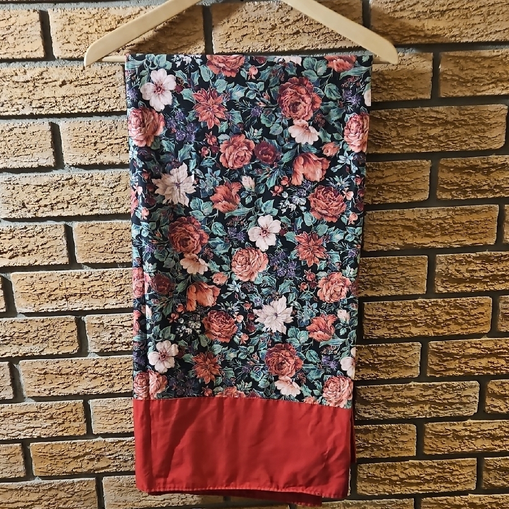Floral Patterned Tabke Cloth with Red Border. Measures 52 X 54